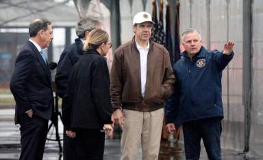 New York Governor Andrew Cuomo gets a briefing from Michael Kopy, the New York State Director of Emergency Management, in New Rochelle