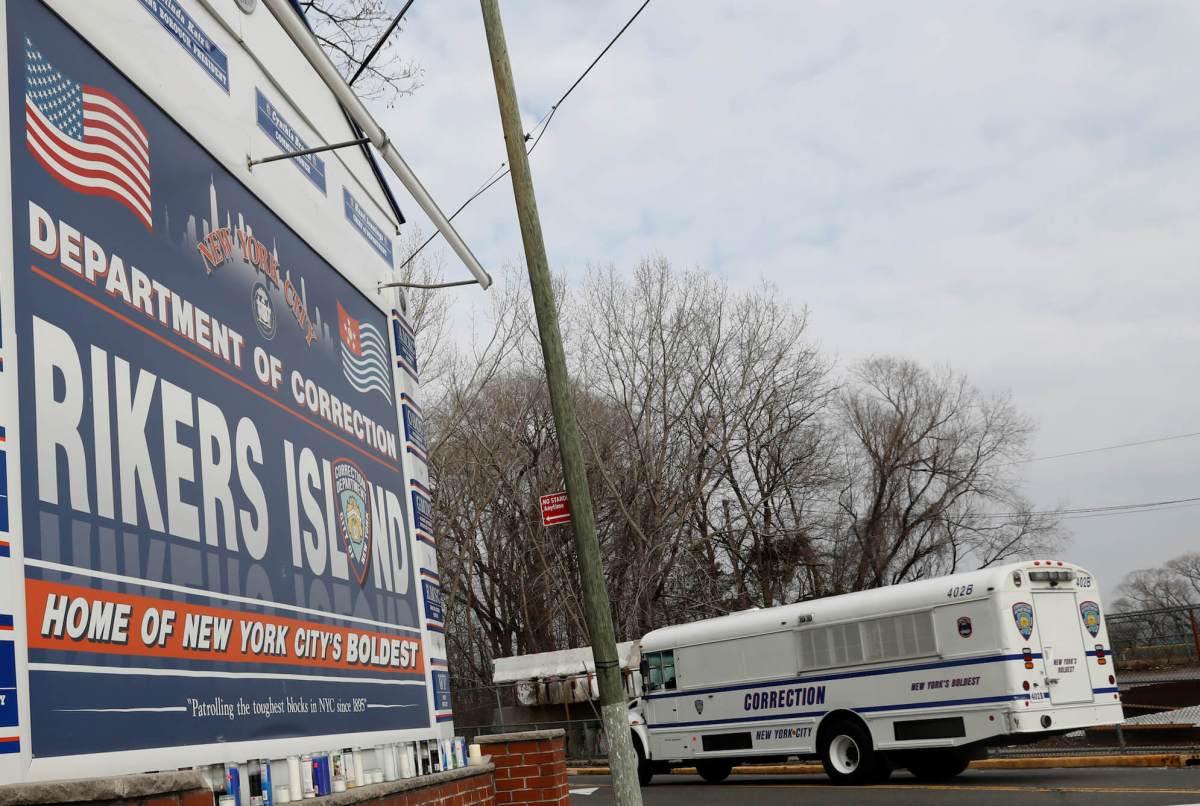 An NYC Department of Corrections vehicle drives in the entrance to Rikers Island facility in Queens, in New York