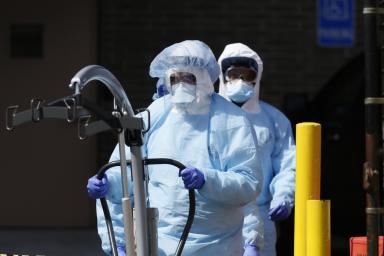 Workers in protective equipment outside Wyckoff Heights Medical Center in Brooklyn during outbreak of the coronavirus disease (COVID-19) in New York