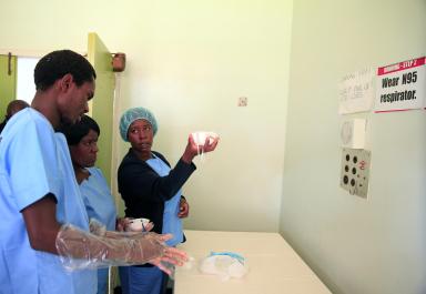 Zimbabwe’s health workers hold masks during a training exercise aimed at preparing workers to deal with any potential coronavirus cases at a hospital in Harare