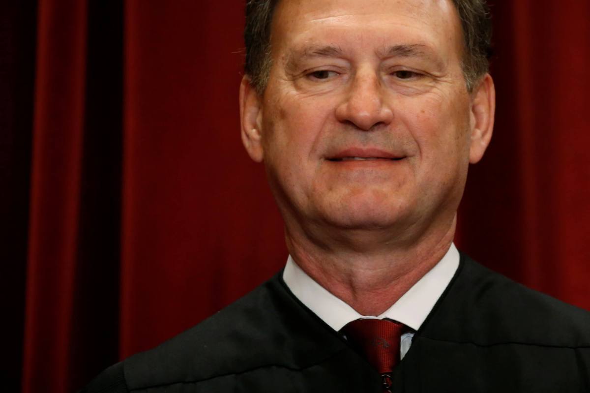 Alito participates in taking a new family photo with fellow justices at the Supreme Court building in Washington