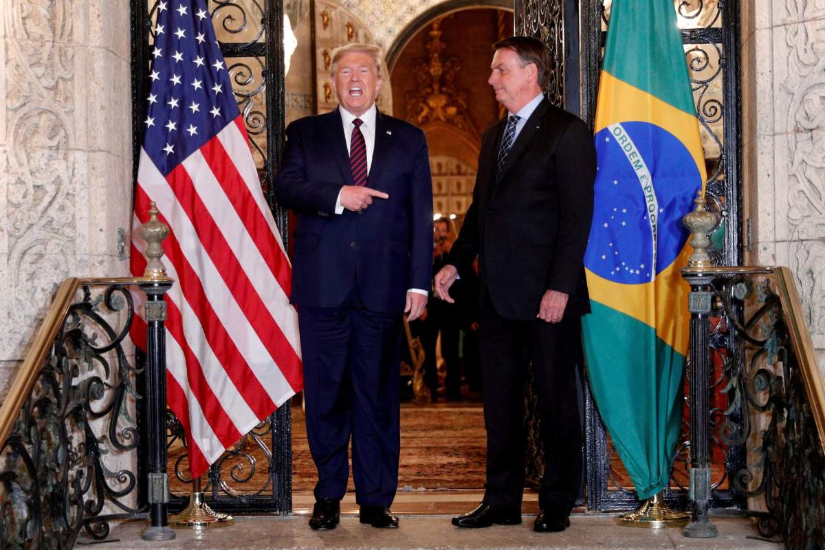 FILE PHOTO: U.S. President Donald Trump participates in a working dinner with Brazilian President Jair Bolsonaro at the Mar-a-Lago resort in Palm Beach, Florida