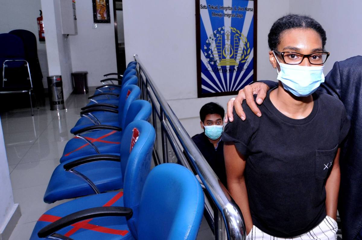 An American woman and self-described digital nomad Kristen Gray looks on after being examined at Indonesian Immigration office in Denpasar