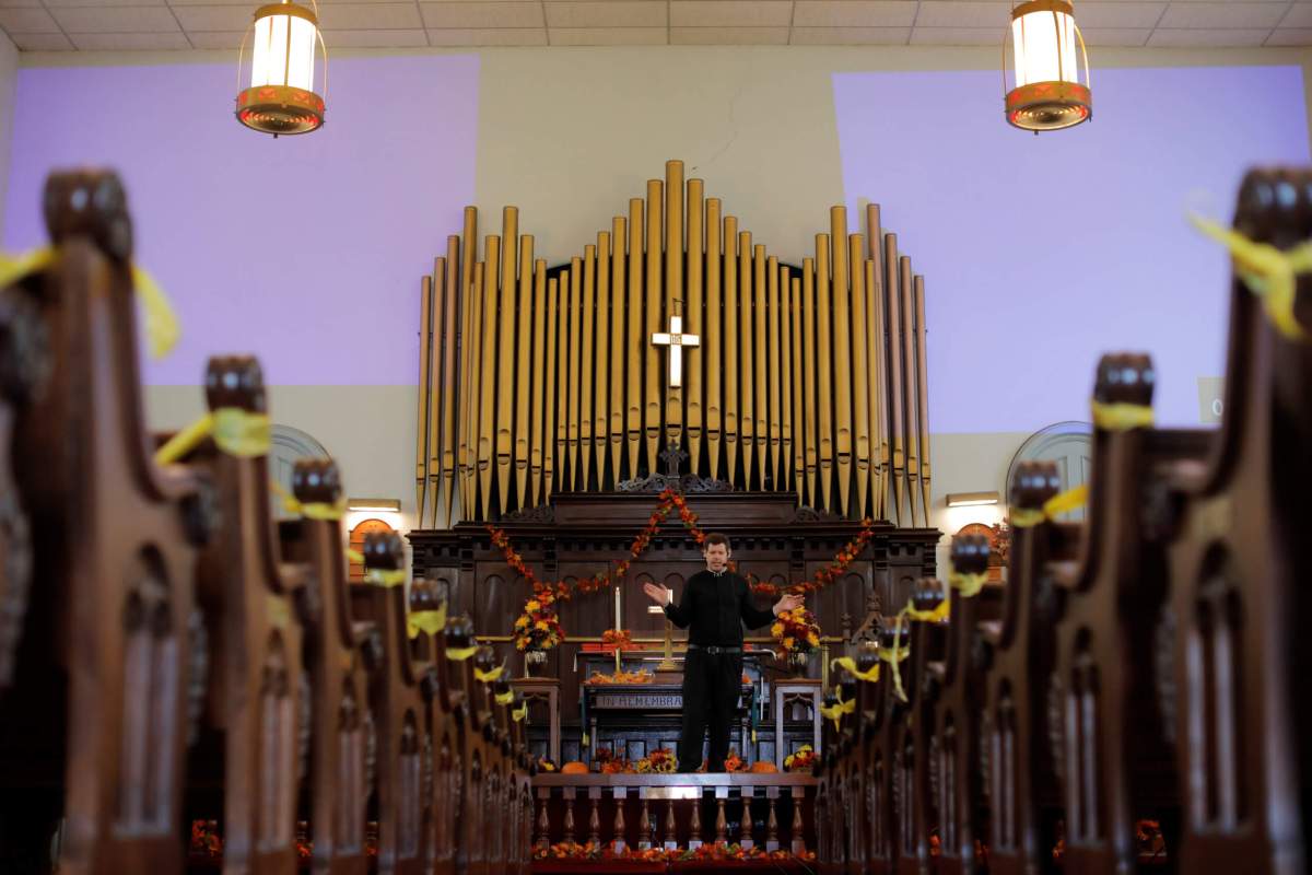 Pastor Kevin Gruver leads mass at Saint Paul’s United Methodist Church, with aisles cordoned off to promote social distancing, on Staten Island in New York City