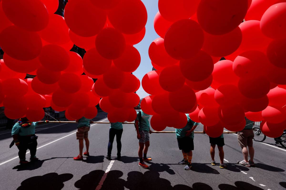 People carry balloons as they participate in the 2018 New York City Pride Parade in Manhattan, New York