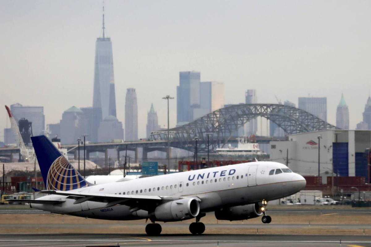 FILE PHOTO: A United Airlines passenger jet takes off with New York City as a backdrop