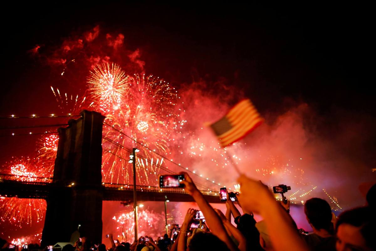 FILE PHOTO: People watch the Macy’s 4th of July Firework Show over the Brooklyn Bridge in New York