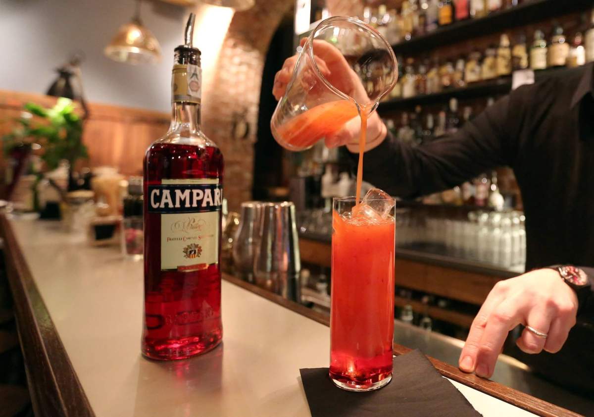 FILE PHOTO: A barman prepare a Campari orange  cocktail in a Milan bar