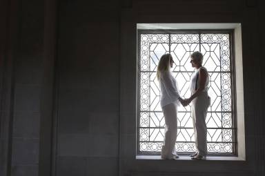 Stacy Wood and her wife Michele Barr pause between wedding photos at San Francisco City Hall after getting married in San Francisco, California