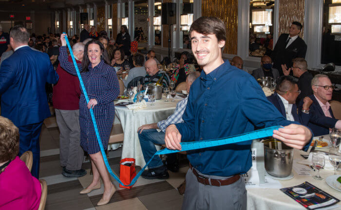 Jackie and Alex Doskoez show the long list of raffle tickets for the evening.