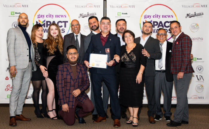 Representatives from Friends Tavern and Viva La Heights Bar stand with Honoree Mauricio Fino.