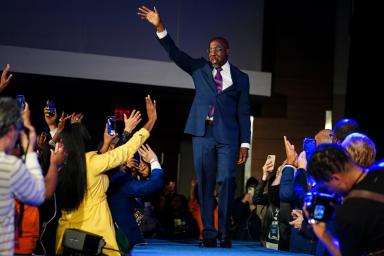 Democratic Senator Raphael Warnock waves to supporters during his election night party.