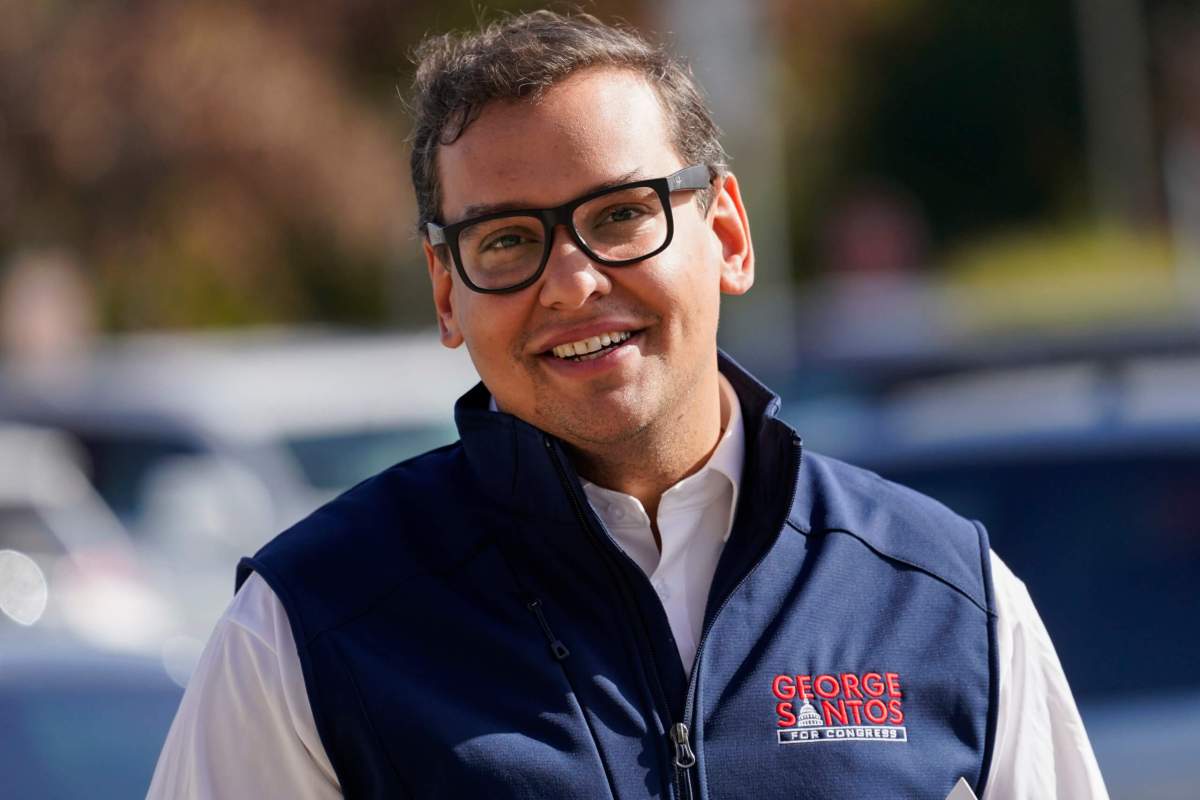 Republican candidate for New York's 3rd Congressional District George Santos campaigns outside a Stop and Shop store, Saturday, Nov. 5, 2022, in Glen Cove, N.Y.