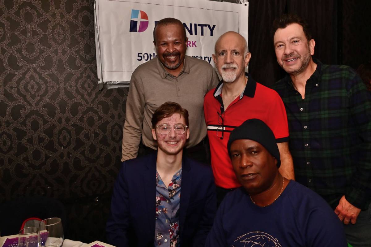 Members huddle together during Dignity NY's 50th anniversary event.