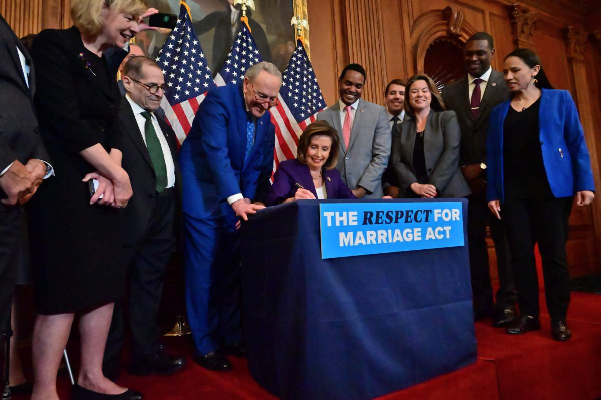 Nancy Pelosi signs the Respect for Marriage Act.