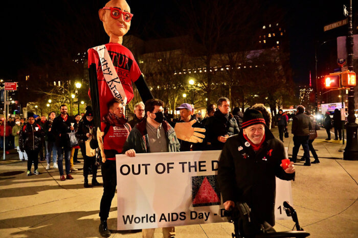 Brent Nicholson Earle leads the march with a Larry Kramer puppet.