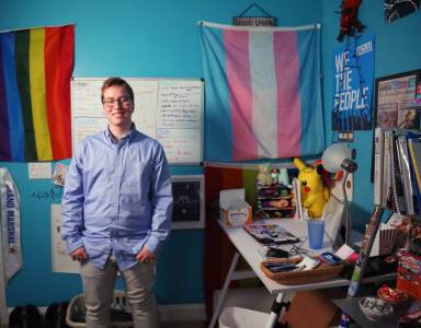 Drew Adams stands in a room.