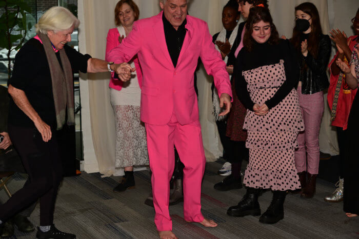 Reverend Billy escorts Ann Northrop to the floor.