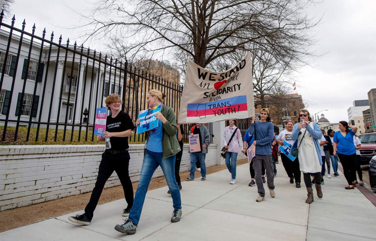 Marchers voicing objection to House Bill 1125 prohibiting transgender-related healthcare in Mississippi for people under the age of 18 walk from the State Capitol to the governor's mansion following a rally at the Capitol in Jackson, Mississippi.