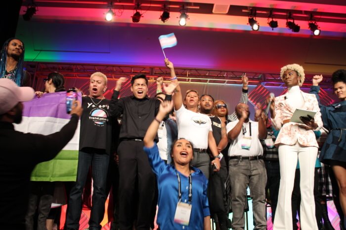 Conference attendees on stage alongside Angelica Ross (right).