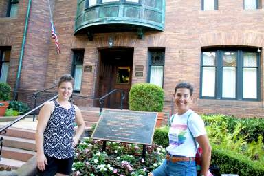 A Tour of Her Own tour guide Ella Schiralli, left, and TOHO founder and president Kaitlin Calogera, right, walk across the rainbow crosswalk in Dupont Circle.