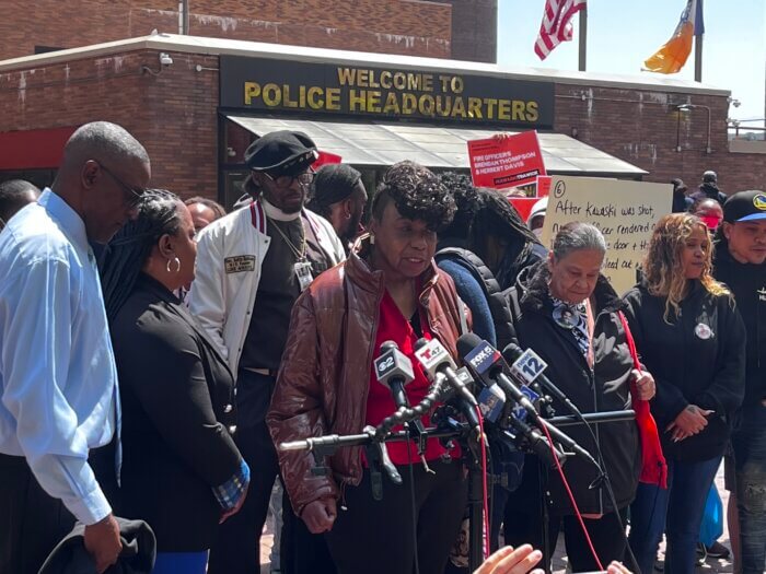 Gwen Carr, the mother of the late Eric Garner, speaks at the podium.