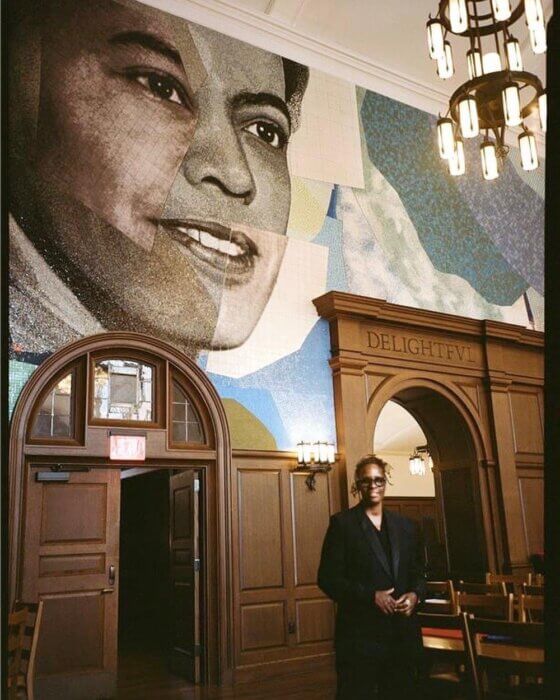 Artist Mickalene Thomas in front of her mural honoring civil and gender rights activist Pauli Murray, at Yale University. 