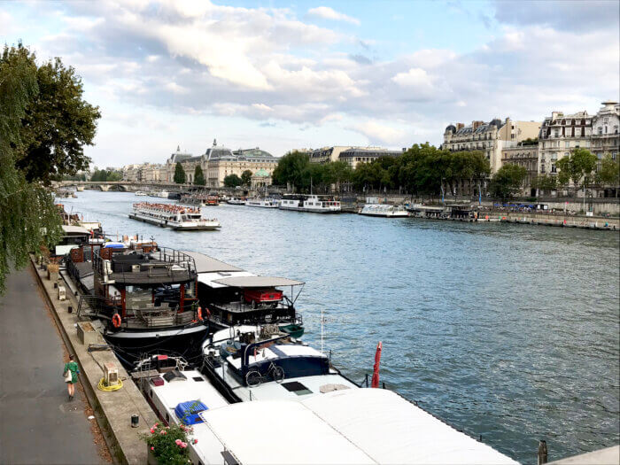 A cruise boat travels down the Seine River in Paris.