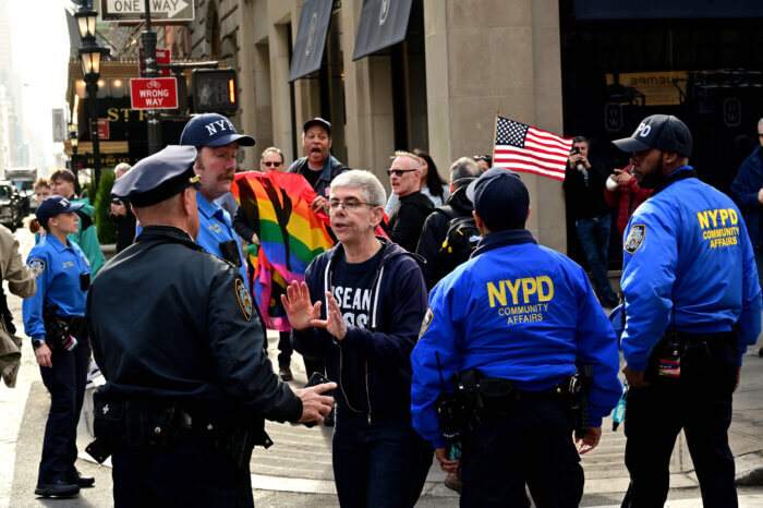 Activist Jamie Bauer pleads with police officers during the chaos.