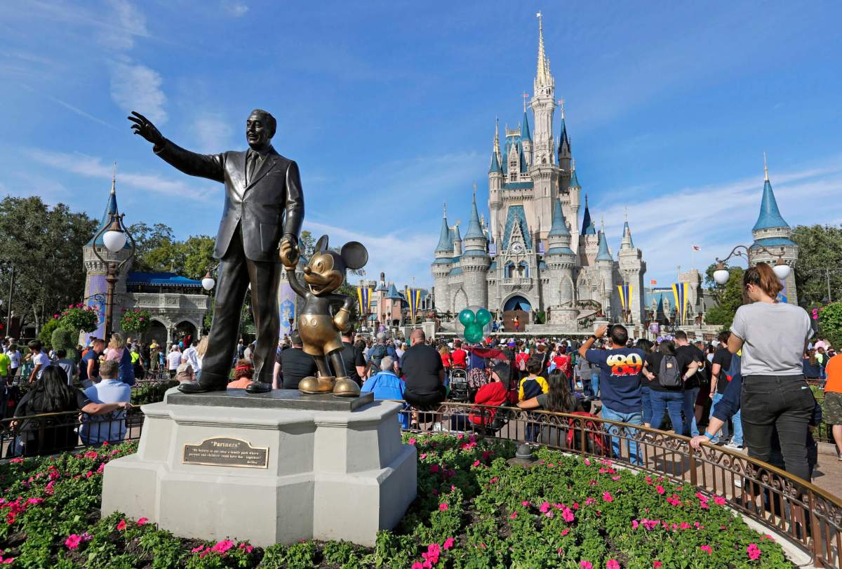 A statue of Walt Disney and Micky Mouse stands in front of the Cinderella Castle at the Magic Kingdom at Walt Disney World in Lake Buena Vista, Fla., Jan. 9, 2019.