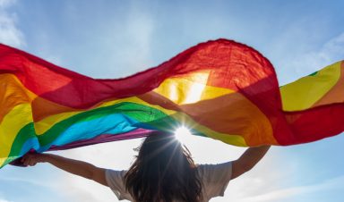 Young woman waving lgbti flag