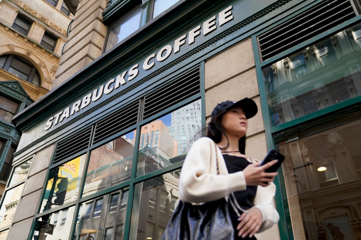 Pedestrians pass a Starbucks in the Financial District of Lower Manhattan, Tuesday, June 13, 2023, in New York.