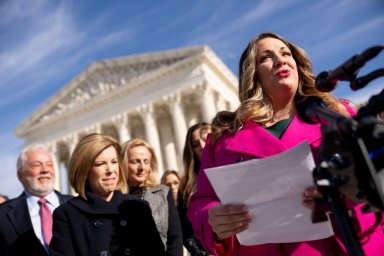 Lorie Smith, a Christian graphic artist and website designer in Colorado, right, accompanied by her lawyer, Kristen Waggoner of the Alliance Defending Freedom, second from left, speaks outside the Supreme Court in Washington, Monday, Dec. 5, 2022, after her case was heard before the Supreme Court.