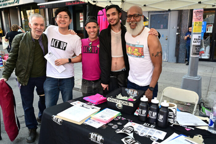 ACT UP's volunteers gather for a picture under their tent.