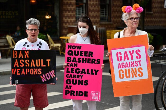 Signs denounce gun violence and lax gun laws.