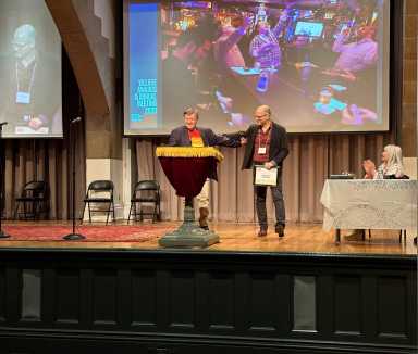 Musician Martin St. Lawrence (left) and general manager Daniel Tobey (right) accept the 2023 Village Award for The Monster Bar from Village Preservation at Cooper Union’s Great Hall on June 13. Penny Arcade (seated, far right) emceed the event.