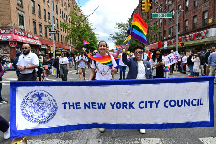 LGBTQIA+ Caucus Co-Chairs Tiffany Cabán of Queens and Crystal Hudson of Brooklyn leads the City Council's banner.