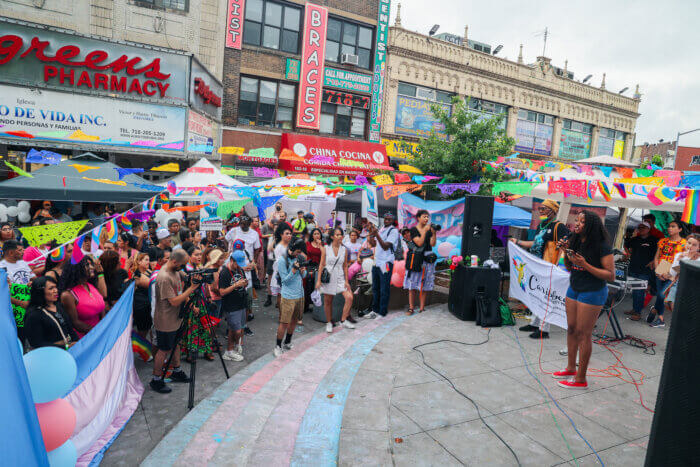 The crowd gathers for speeches at Corona Plaza.