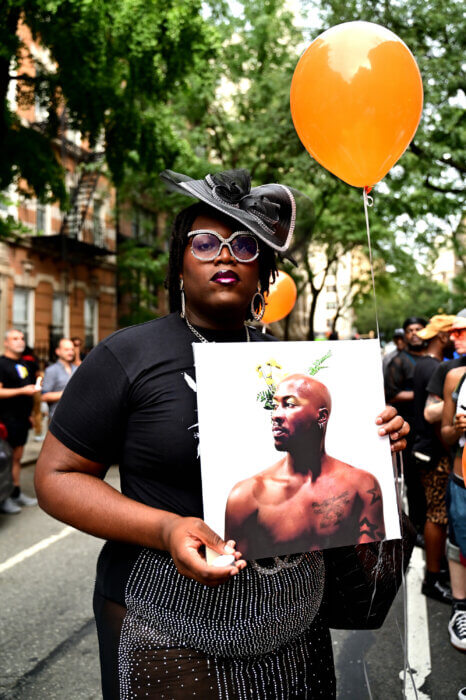 Qween Jean holds a picture of O'Shae Sibley.