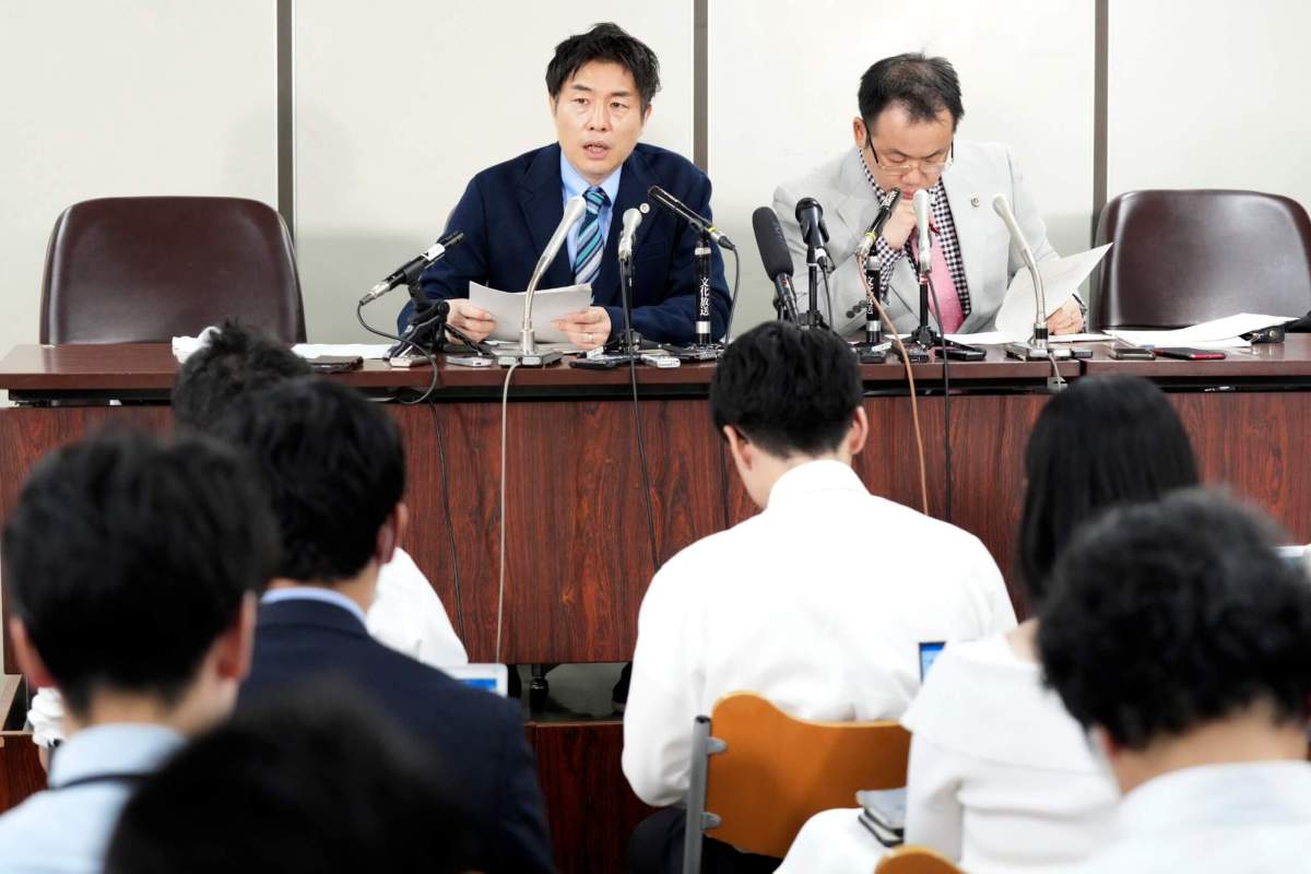 Lawyers of a claimant, Kazuyuki Minami, left, and Masafumi Yoshida, right, speak to media after the ruling of the Supreme Court Wednesday, Oct. 25, 2023, in Tokyo.