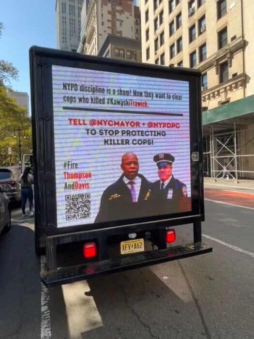 A truck calling for accountability in the Trawick case is parked in the road along Broadway.