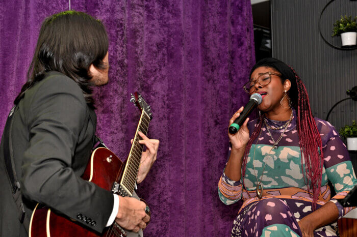 Desiree Banister sings while Koa Ho plays guitar.