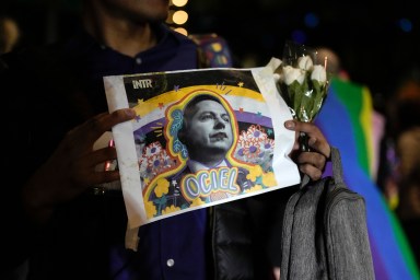 A demonstrator holds a picture of Aguascalientes state electoral court magistrate Jesus Ociel Baena in Mexico City on Nov. 13, 2023. The first openly nonbinary person to assume a judicial position in Mexico was found dead with their partner at home Monday in the central Mexican city of Aguascalientes after receiving death threats because of gender identity, authorities said.