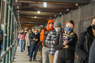 Individuals wait to receive the COVID-19 vaccine in January of 2021.