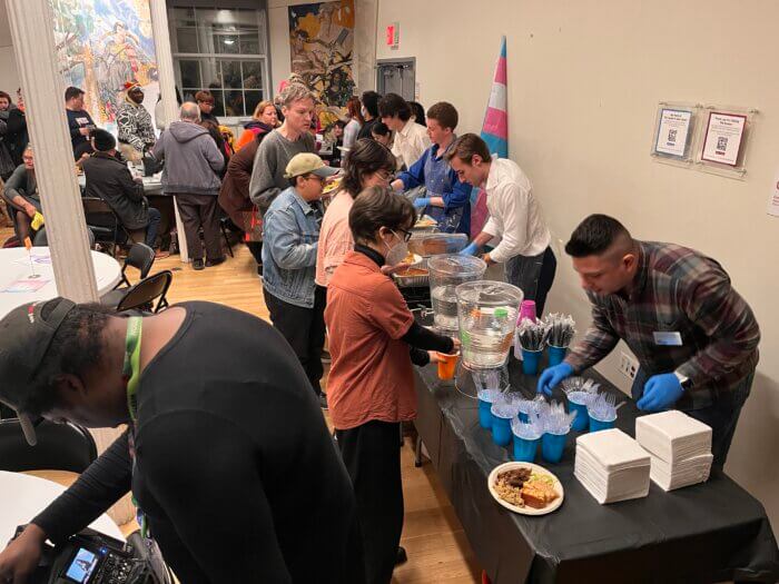 Attendees stand in line for food after a Transgender Day of Remembrance event at The LGBT Center.