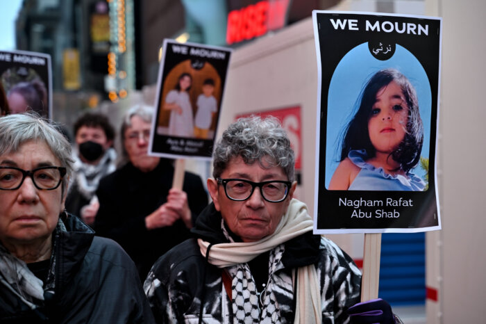 Katherine Acey carries a sign during the silent march.