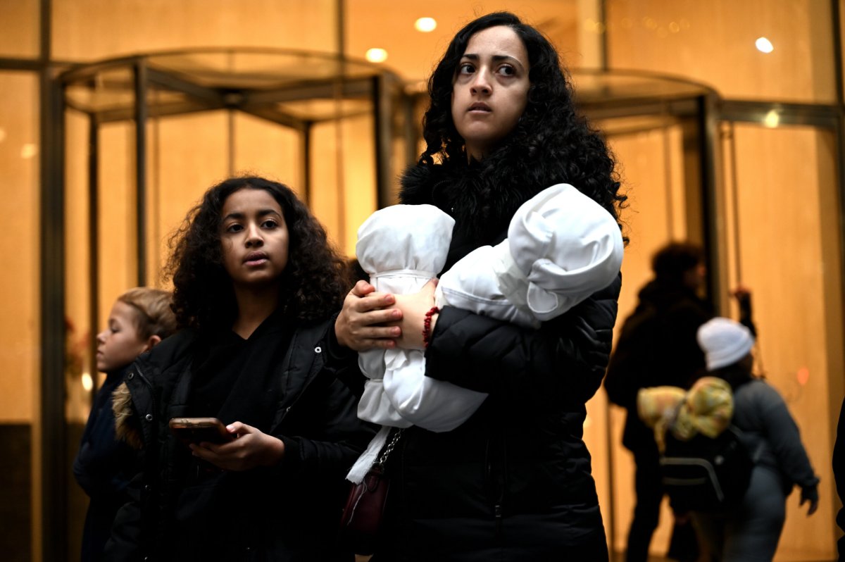 A marcher prepares to lay her effigies to rest in Manhattan on Dec. 28.