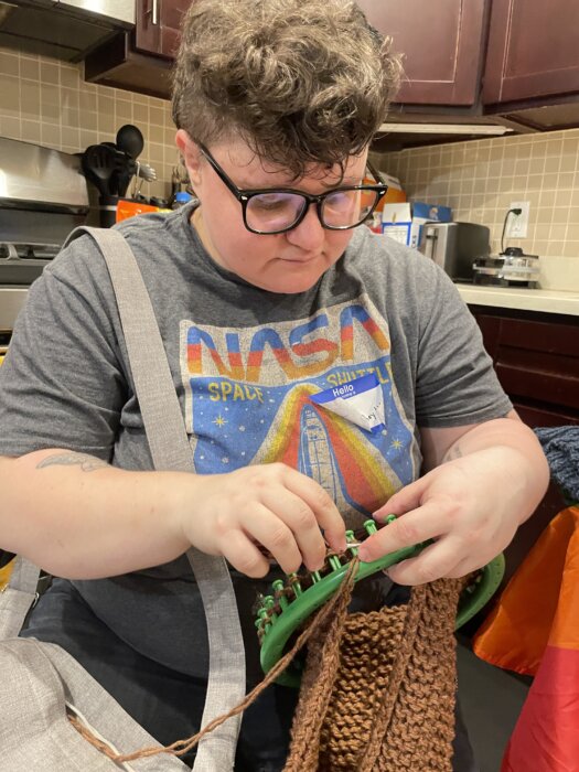 Tee Hoida works on a garment on their loom during the day of action.