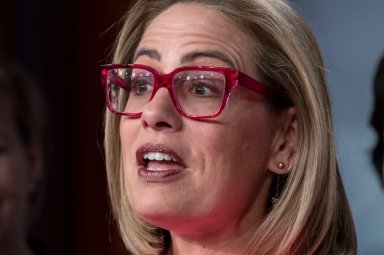 Sen. Kyrsten Sinema, of Ariz. speaks to reporters at the Capitol in Washington, Nov. 29, 2022.