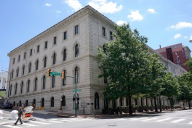 A pedestrian passes by the US 4th Circuit Court of Appeals Courthouse on Main Street in Richmond, Va., Wednesday, June 16, 2021.